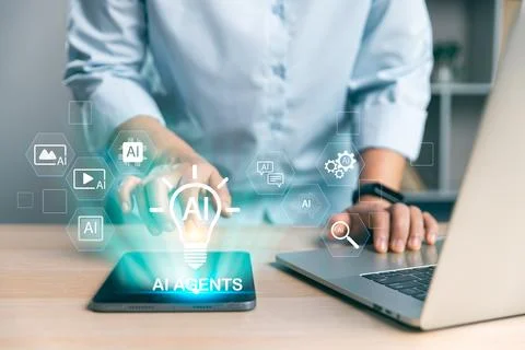 Office worker using tablet and laptop with glowing AI agents interface, sym.. Stock Photos