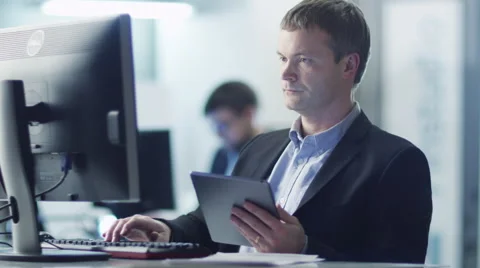 Office Worker is Using Tablet at Work in Office Video stock 47388404