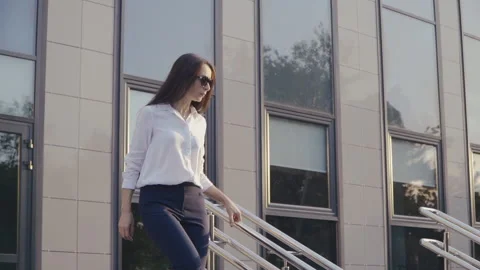 Office worker walking down the Stairs Video stock 136392370