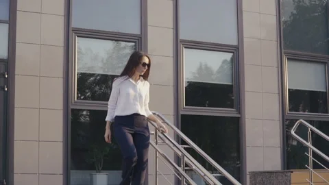 Office worker walking down the Stairs Video stock 136392422