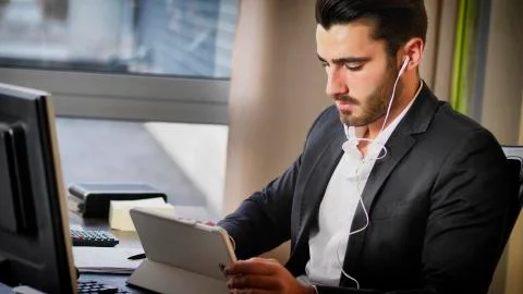 Office worker watching tablet at workplace Stock Photos