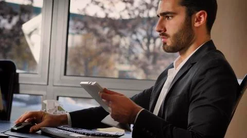 Office worker watching tablet at workplace Stock Photos