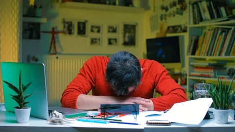 An office worker woke up at a desk in the workplace. Shot by a banana. Stock Footage 120012828