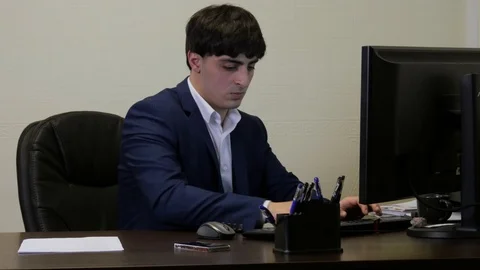 Office worker working on the computer and after a phone call in a hurry to Video stock 102123583