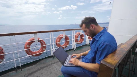 Office worker working with laptop on ferry boat. Video stock 212543966