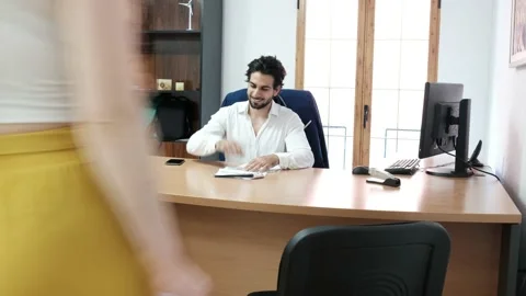 Office worker in workplace. Couple interview with young businessman Stock Footage 134532262