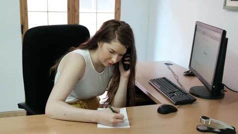 Office worker in workplace.  Smiling blonde woman at phone Stock Footage 134554501