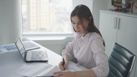 Office worker works with documents and drawings in the office Stock Footage 105394764