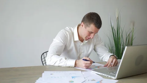Office worker works with documents and laptop 스톡 동영상 107942010