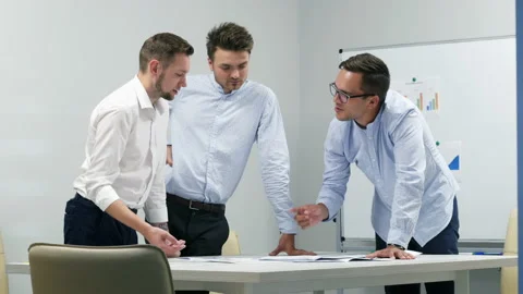 Office workers actively discuss a project, come to an agreement, look at graphs Stock Footage 141717730