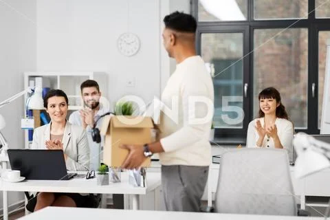 Office workers applauding to male colleague Stock Photos
