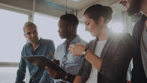 Office workers are friendly, they are dressed in a watch room, an international Stock Footage 100972576