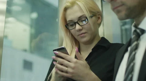 Office Workers are Using Mobile Mobile Phones in Elevator Stock Footage 39970149