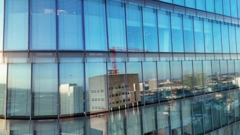Office workers behind reflective glass facade at dusk Stock Footage 332627847