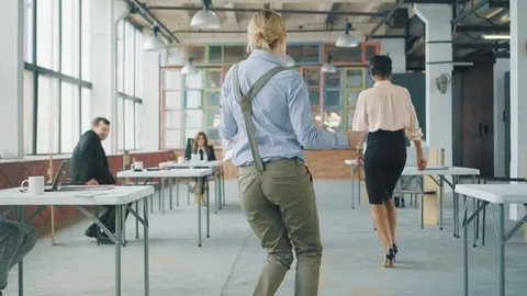 Office workers celebrate and dance. Creative office interior in loft style Stock Footage 107928813