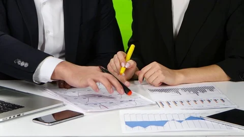 Office workers check their data by plotting graphs. Green screen Stock Footage 71357024