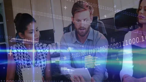 Office workers collaborating at desk in tech office, featuring binary code and Stock Footage 307443691