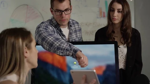 Office workers collaborating on project man points at screen of tablet 스톡 동영상 78732670