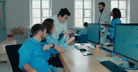 Office workers communicating together and discussing a project on a computer scr 스톡 동영상 95764729