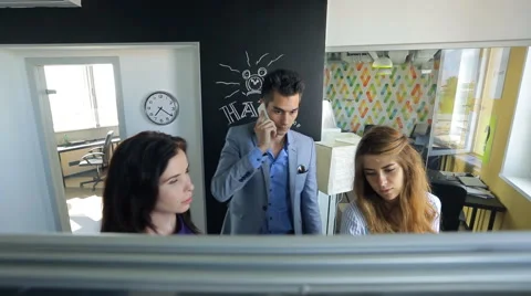 Office workers discuss a joint work plan near board for drawing markers, man Stock Footage 66189040