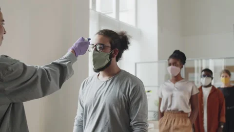 Office Workers in Face Masks Getting Contactless Temperature Check Up Stock Footage 138149460