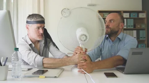 Office workers fighting over the electric fan Stock Footage 297861274