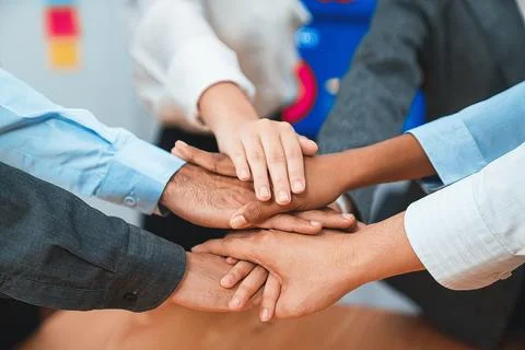 Office worker's hand stack shows solidarity in workplace. Concord 스톡 사진