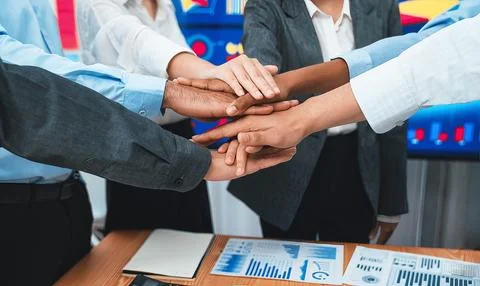 Office worker's hand stack shows solidarity in workplace. Concord 스톡 사진