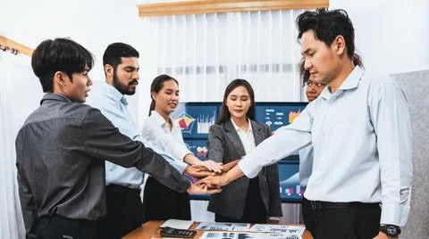 Office worker's hand stack shows solidarity in workplace. Concord Stock Photos