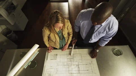Office Workers Look at Blueprints. Crane up 스톡 동영상 62921995