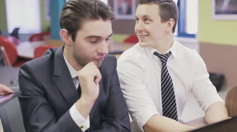 Office workers looking at laptop and discussing Stock Footage 63226936