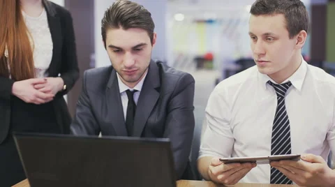 Office workers looking at laptop and discussing 스톡 동영상 63254795