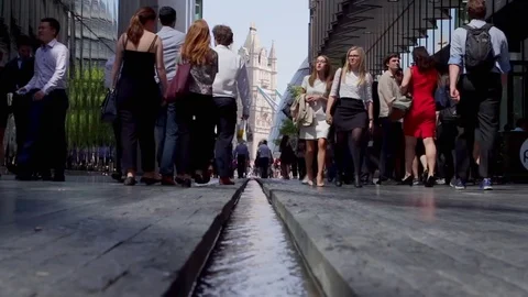 Office workers pass a manmade stream near Tower Bridge 動画素材 75996210