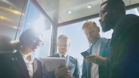 Office workers riding elevator Stock Footage 121144229