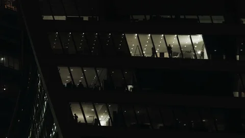 Office workers seen in the windows of a large office building in Moscow Vídeos de archivo 96587107