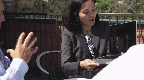 Office workers showing work on laptop Stock Footage 67351979