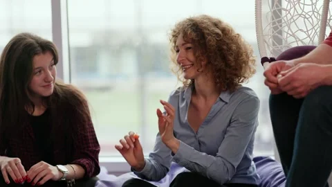 Office workers spend time in the relax room. A group of workers communicate Stock Footage 243367631