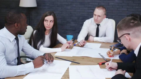 Office workers standting at the table and discussing a project Stock Footage 95715519