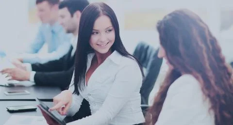 Office workers with a tablet in front of computer, doing the fin Stock Photos