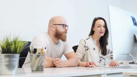 Office workers talking and using computer Stock Footage 96494707