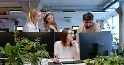 Office workers talking at computer and watching at screen. Male ad females Stock Footage 180020958