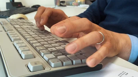 An office workers types on a keyword Video stock 123440049