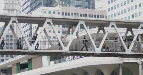 Office workers walk at the Dukuh Atas crossing bus stop Video stock 329537613