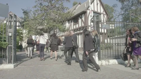 Office workers walk into yard Stock Footage 77049491