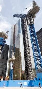 Office workers walking under a skyscraper Stock Photos