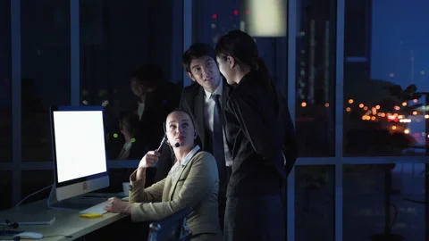 Office workers working in call center services are working overtime Stock Footage 138884632