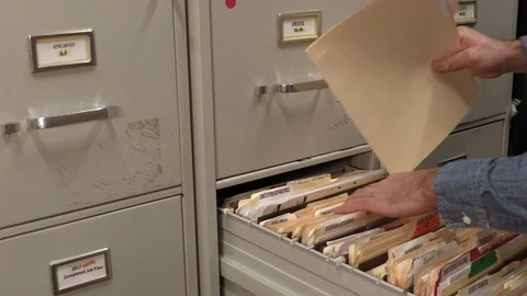 Office Working Filing a Folder in a File Cabinet. Stock Footage 106758464