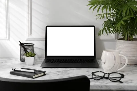 Office workplace with computer, glasses, cup and stationery on marble table.. Stock Photos
