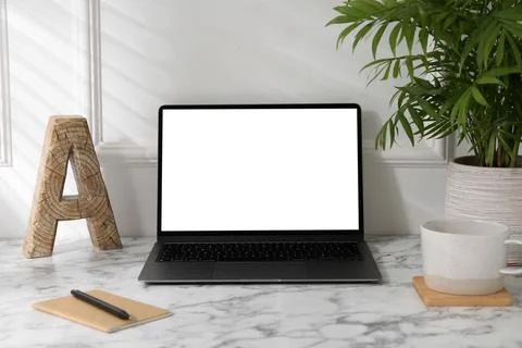 Office workplace with computer, glasses, cup and stationery on marble table.. Stock Photos