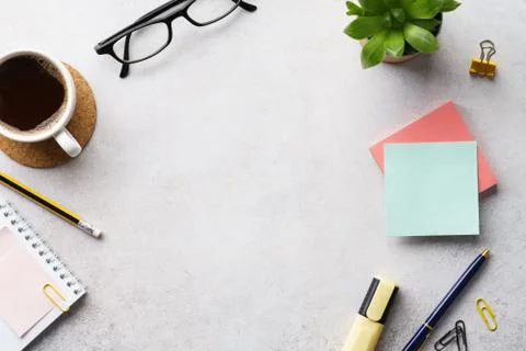 An office workplace with a cup of coffee, notepad and stationery Stock Photos